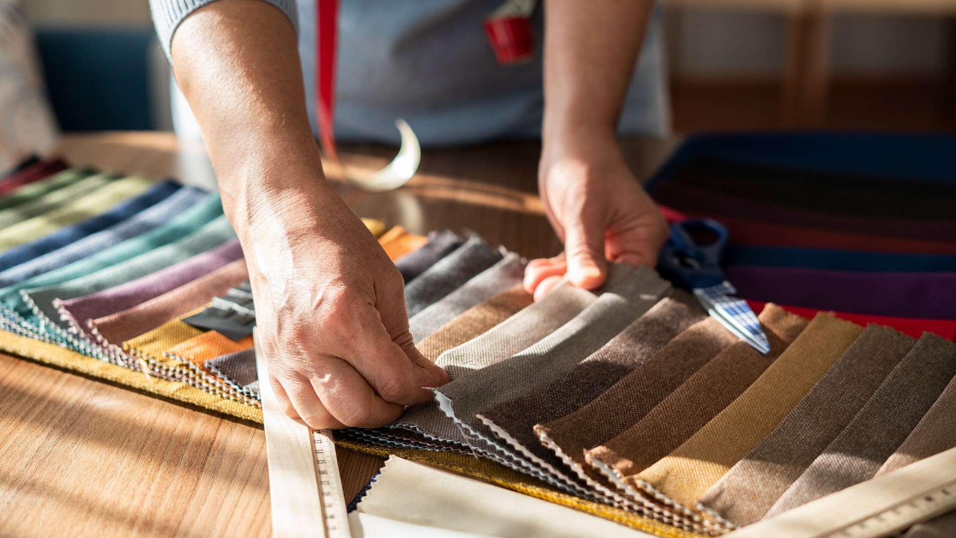 Close-up Adult female designer choosing fabric color for new project